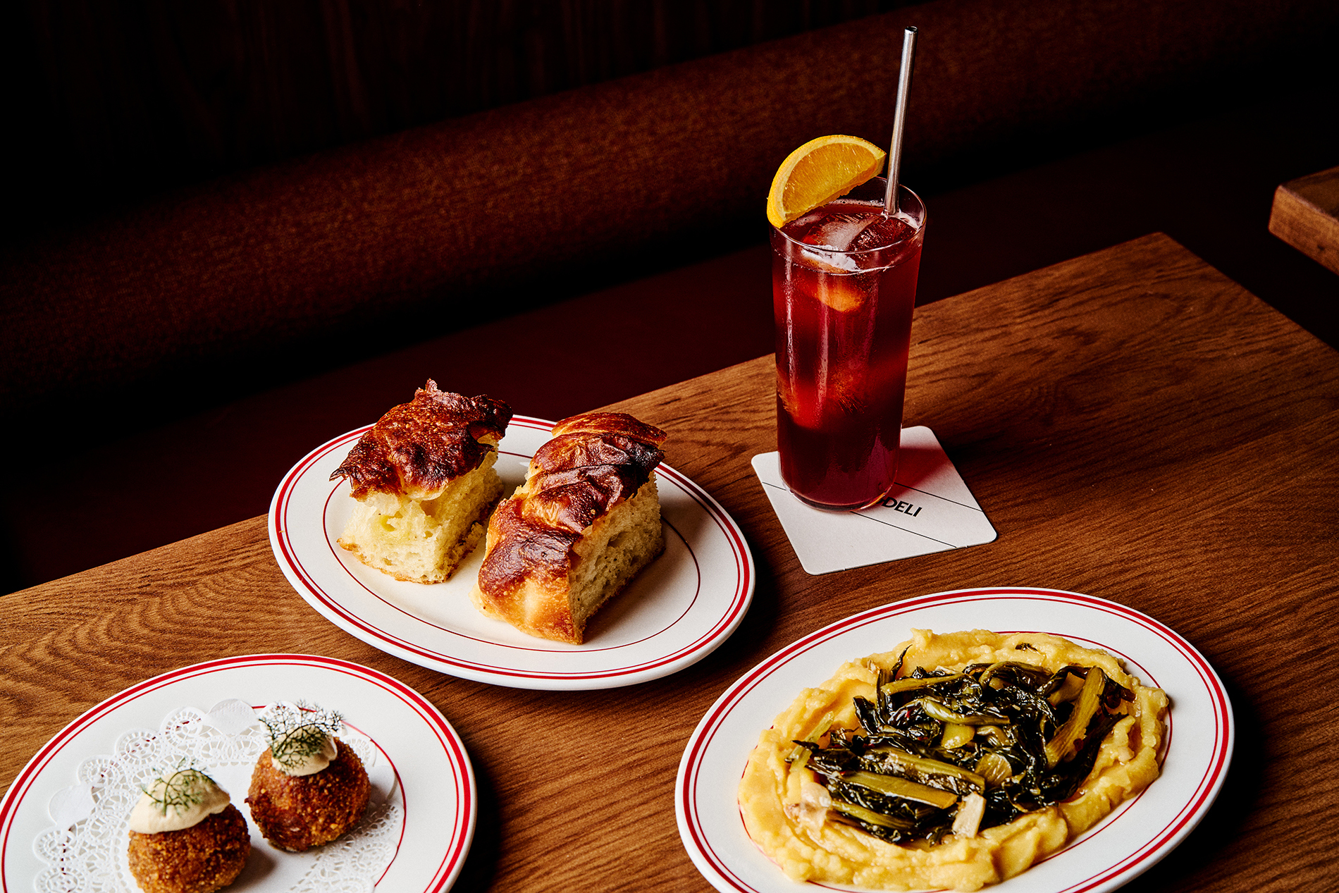 A cocktail and tapas on a table.