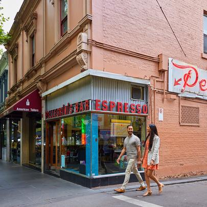 A couple walking past a restaurant