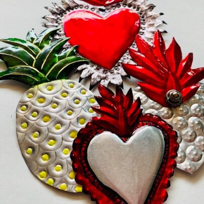 Pressed-tin decorations including hearts and pineapples.