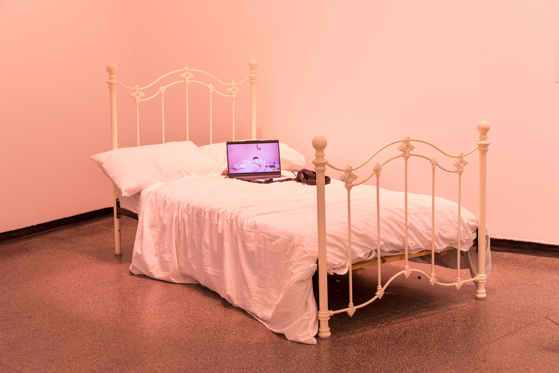 A bed with a laptop on it