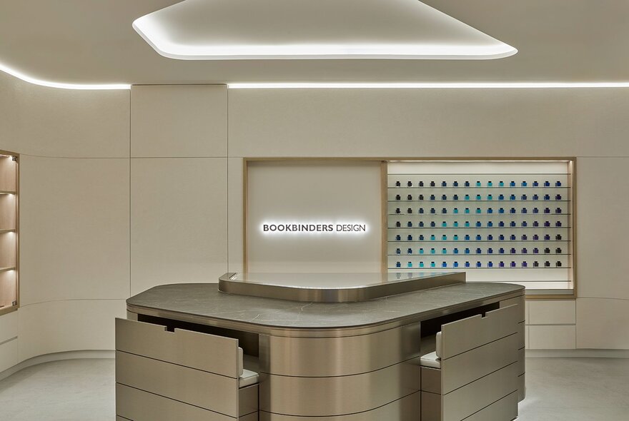 Store interior with beige walls and wooden central bench table.