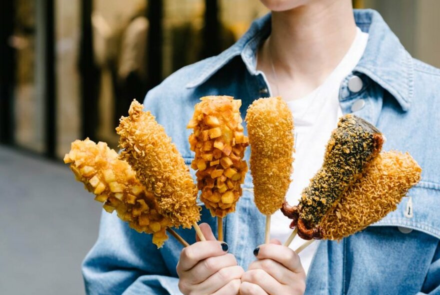 girl holding corn dogs