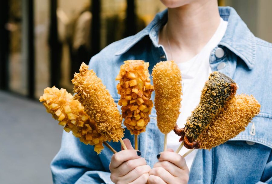 girl holding corn dogs