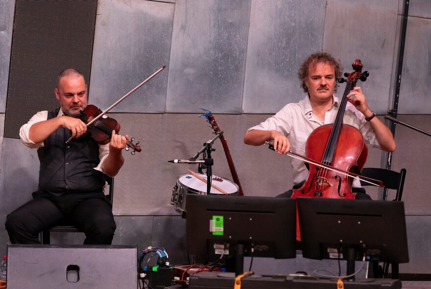 A violinist and cellist performing together at Fed Square.