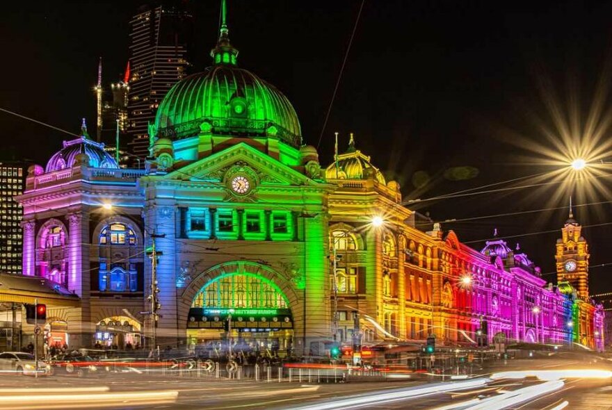 A train station lit up at night