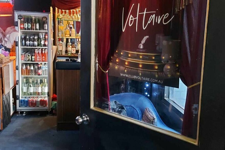 Fridges surrounding a picture of a theatre on a door.