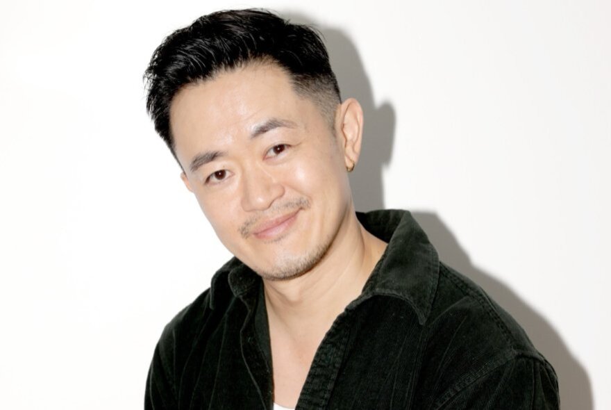 Benjamin Law, smiling with his head on one side.