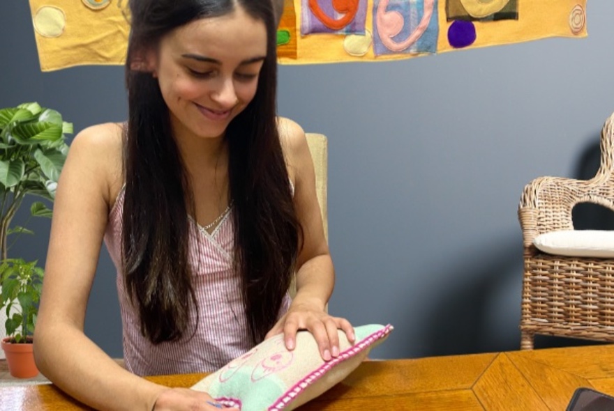 Person crafting wool toy.