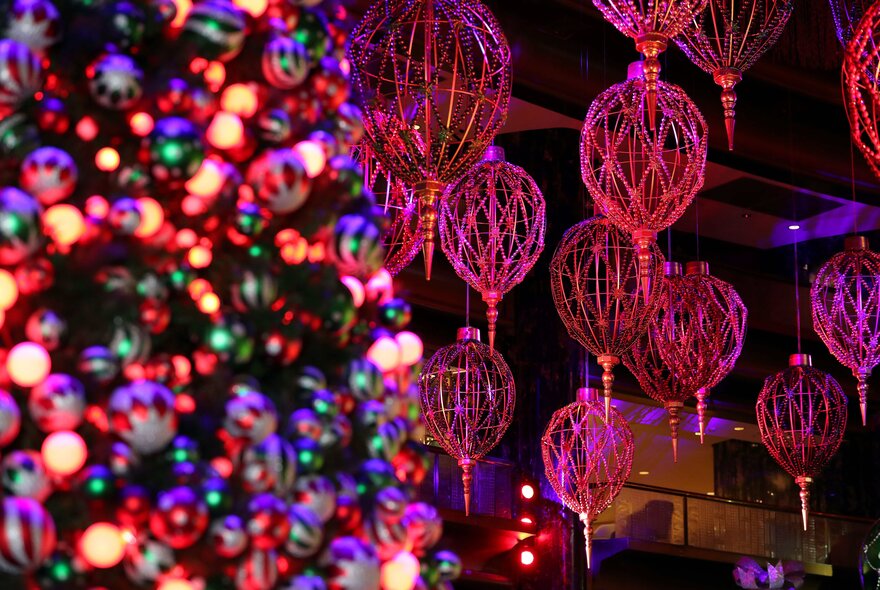 Christmas decorations hanging in the Atrium at Crown with a Christmas tree in the background.