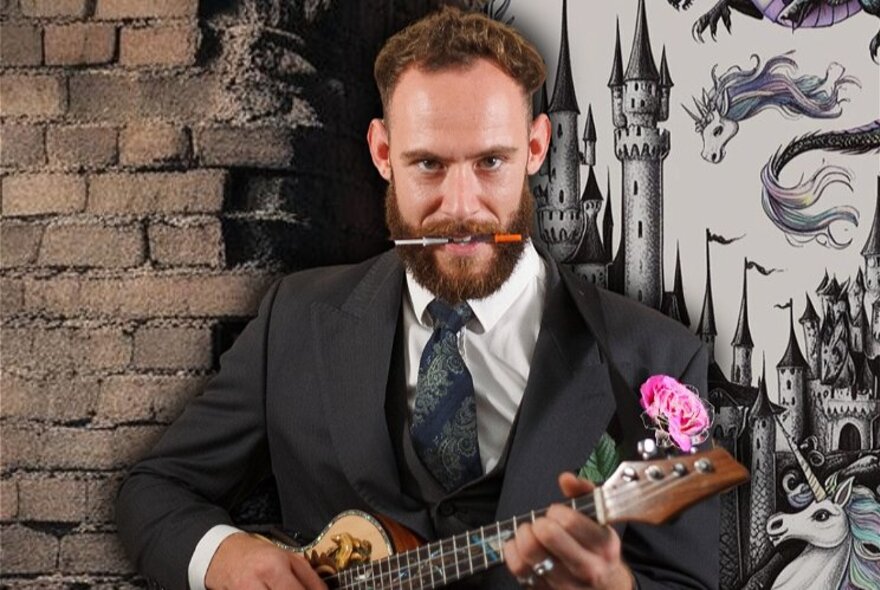 A man with a pencil in his mouth playing the ukulele with a carnation on the top, castle and dragons wallpaper behind him. 