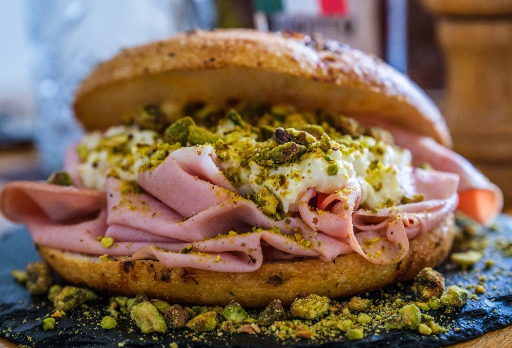 A focaccia sandwich with meat and cheese inside
