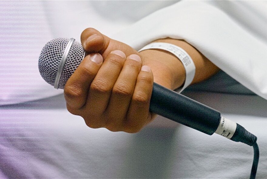 Hand holding a microphone.