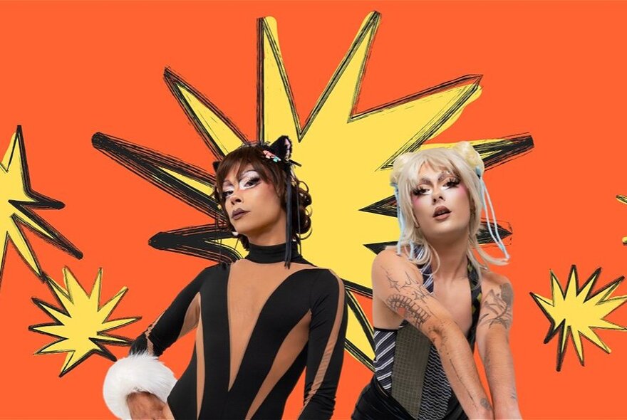 Two drag performers wearing wigs, theatrical make-up and stage costumes, posed in front of an orange backdrop with large yellow stars on it.