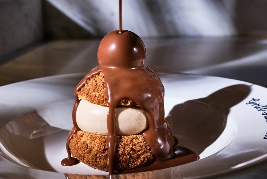 Chocolate and pastry dessert on a white plate.