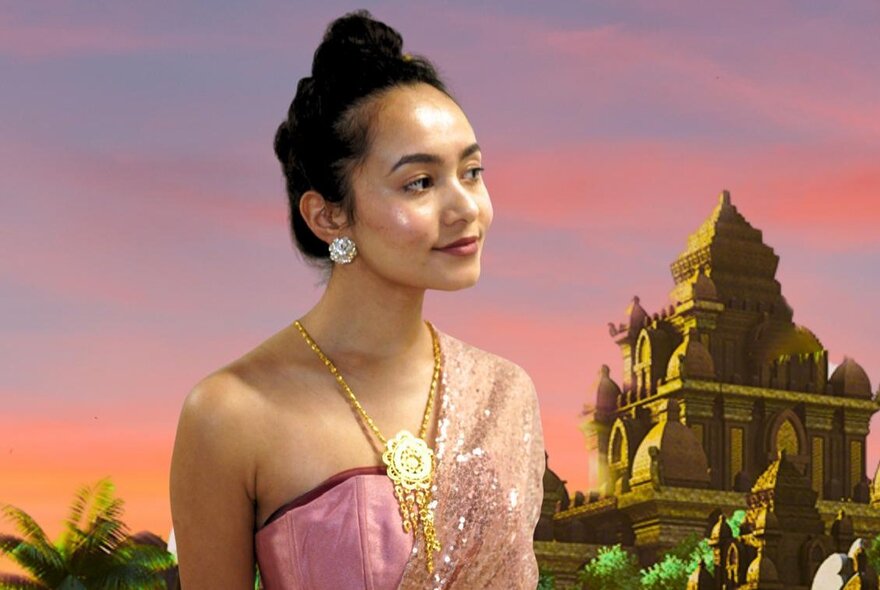 A young Indonesian woman wearing traditional clothes in front of a multi-tiered temple.