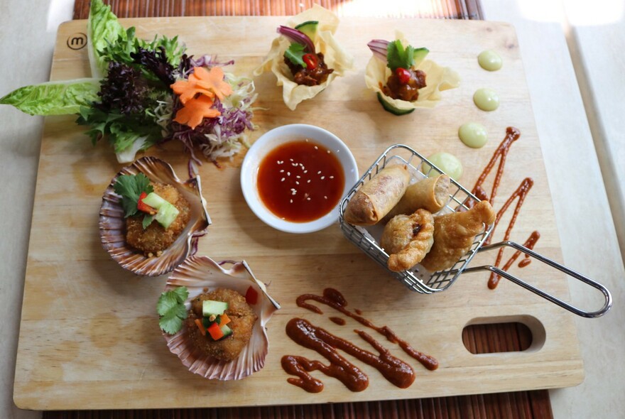 Looking down on a table with a mixture of Thai started dishes.