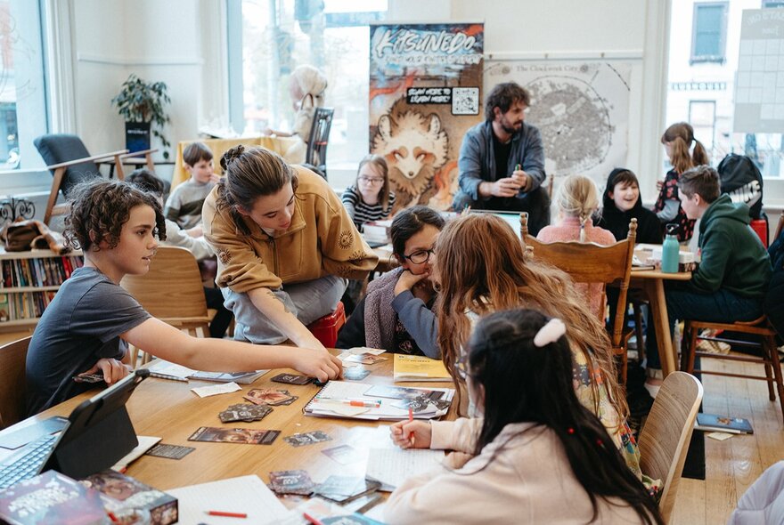 Children working at tables in a workshop setting.