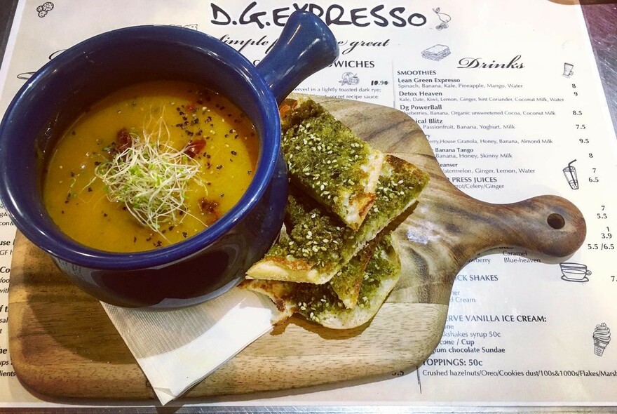 Blue ramekin of soup, with focaccia on side.