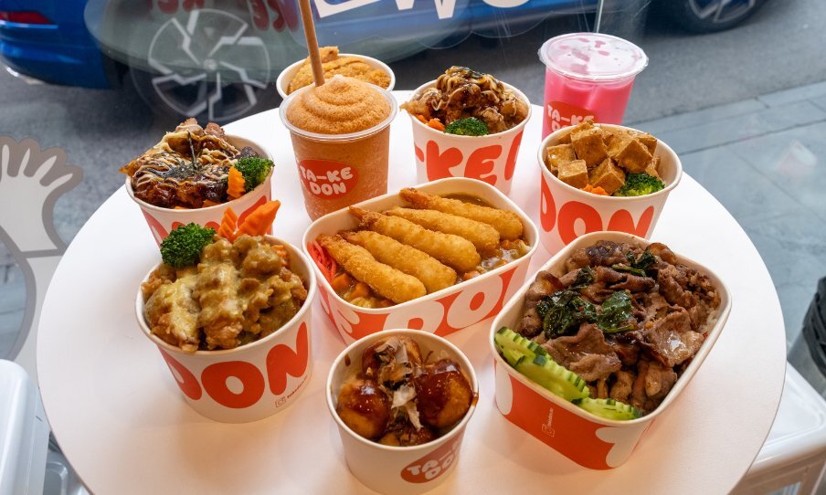 Takeaway boxes of food on white table