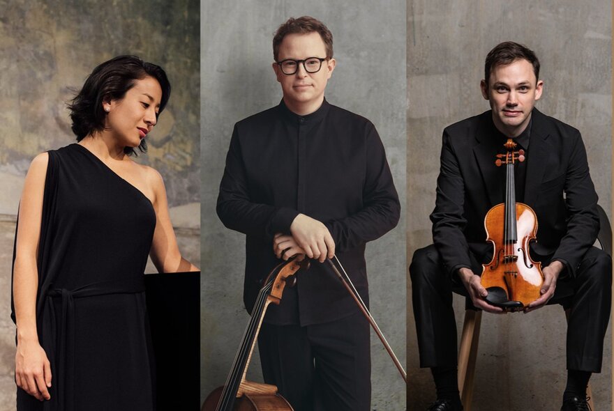 Classical musicians wearing black, holding their instruments.