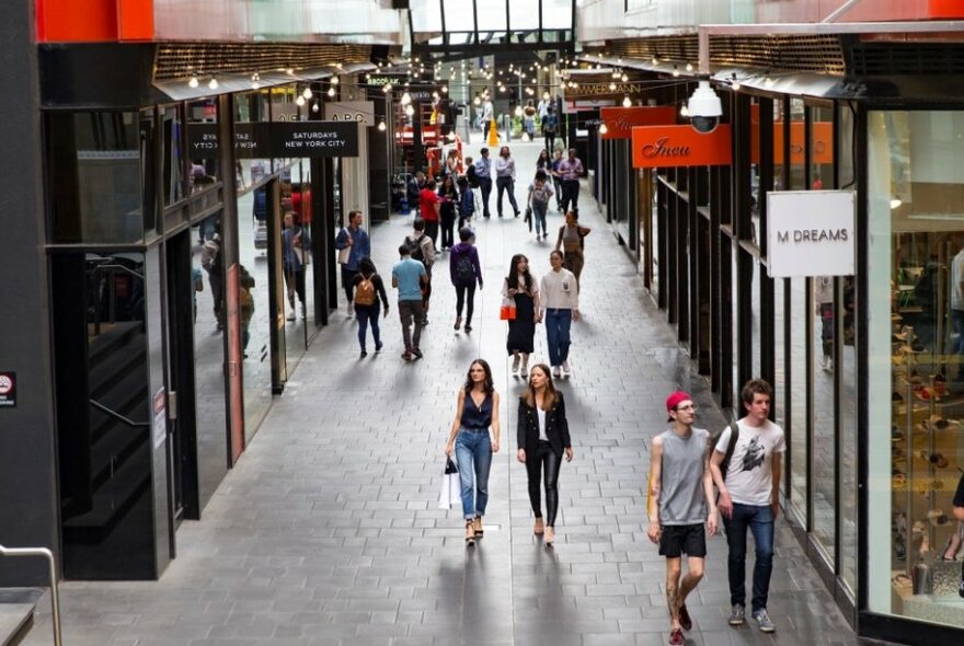 Shoppers in a laneway shopping strip in QV Melbourne.