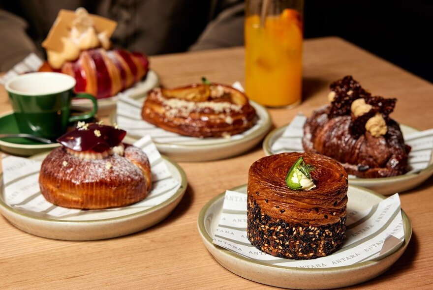 A table with plates of pastries on it