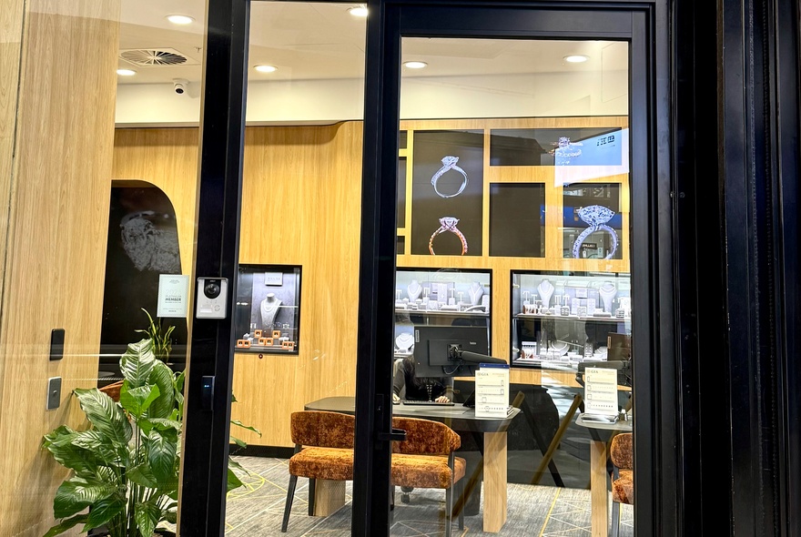 The exterior of Janai jewellery store, looking through large glass windows into the shop. 