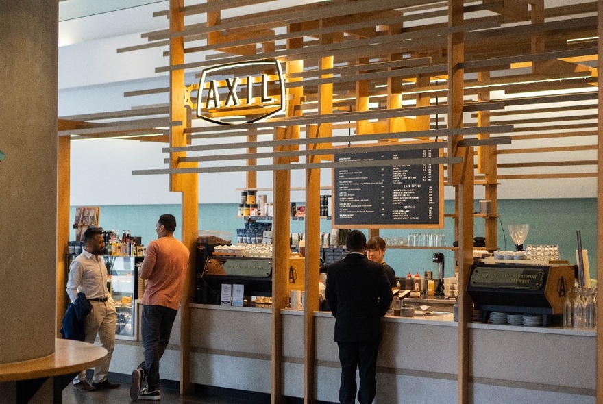 Interior of Axil Coffee Lonsdale St, with people ordering at a large service counter.