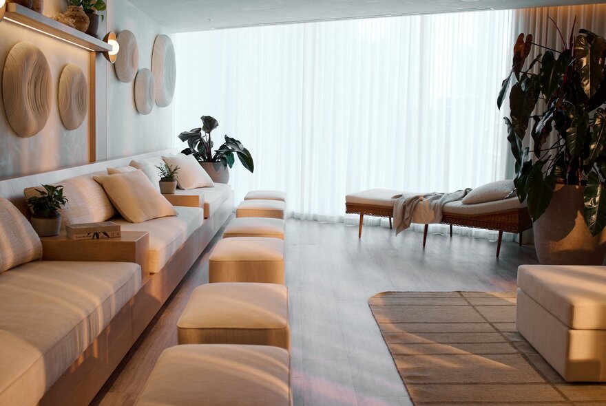 The Bamford Wellness Spa at 1 Hotel, with soft furnishings in neutral colours against the walls, plants and rugs creating an inviting space.