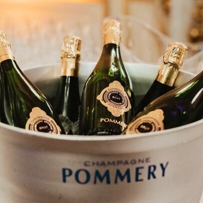 Ice bucket full of bottles of Champagne on ice.