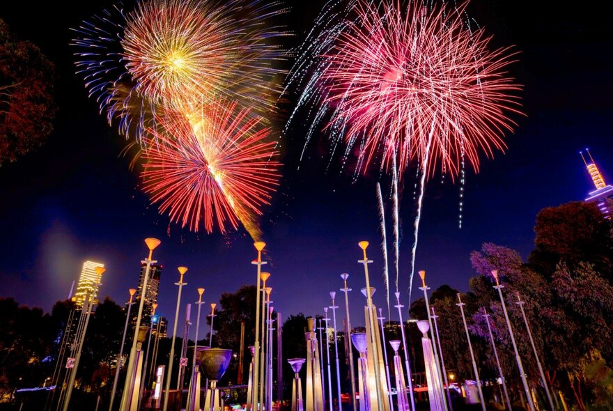 Fireworks over Melbourne's skyline with banner poles.
