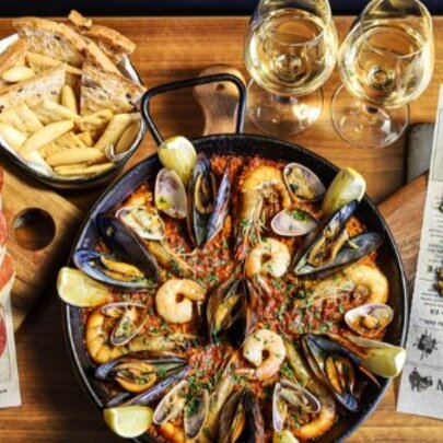 Looking down at platters of assorted tapas, and two glasses of wine.