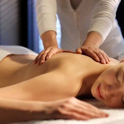 A woman getting a massage at a luxury spa.
