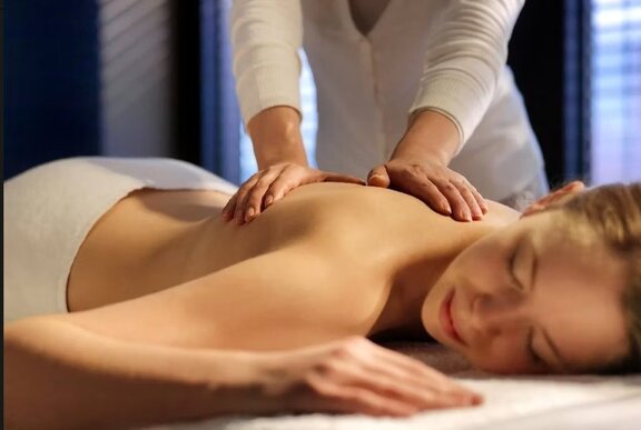 A woman getting a massage at a luxury spa.