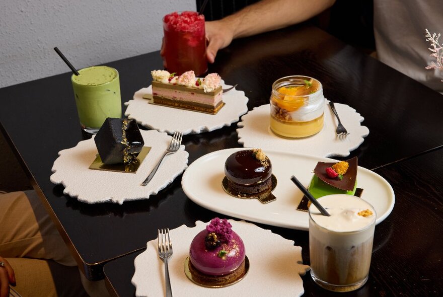 An assortment of small cakes and dessert drinks.