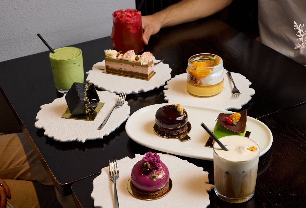 An assortment of small cakes and dessert drinks.