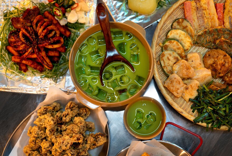 An assortment of Korean dishes including Korean fried chicken, matcha rice wine and savoury pancake.