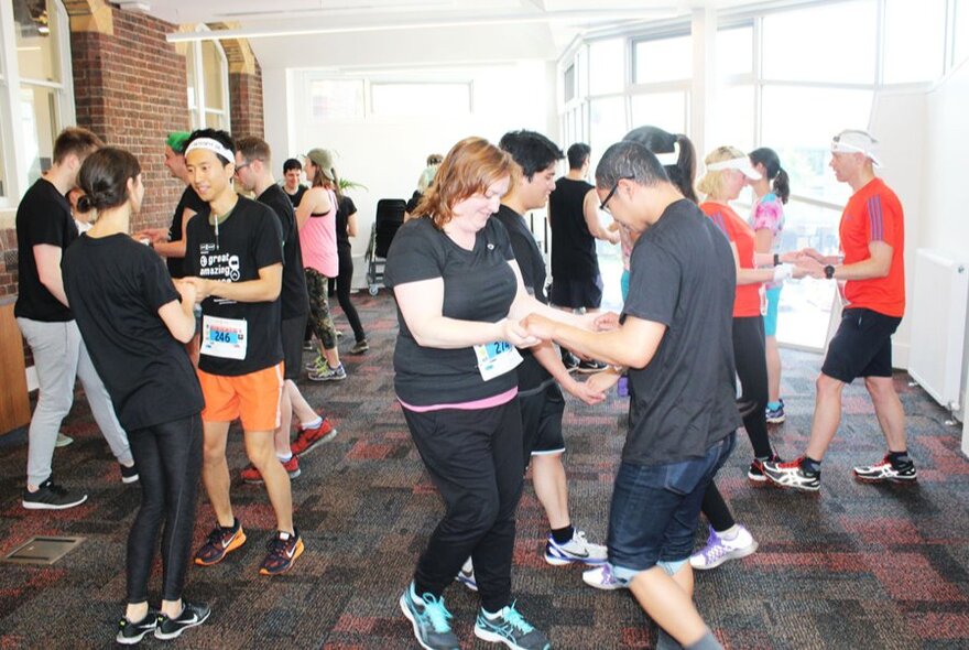 People in pairs participating in an indoor competition.