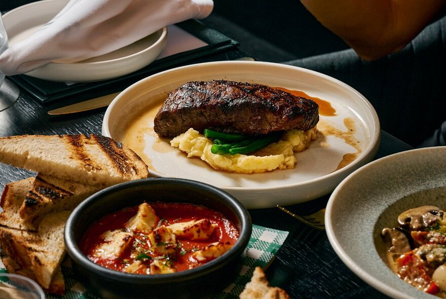 A selection of delicious-looking dishes, including a steak and mash dish, a tomato-based hot pot and a mushroom pasta.