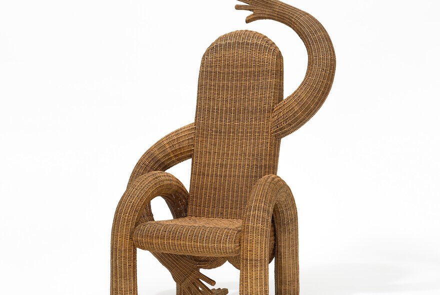 A woven chair with arms.
