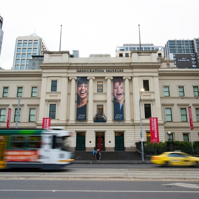 Three-storey historic building of the Immigration Museum on busy Flinders Street.