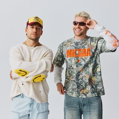 Electronic duo Sidepiece, two men standing side-by-side against a plain white background, wearing casual streetwear.