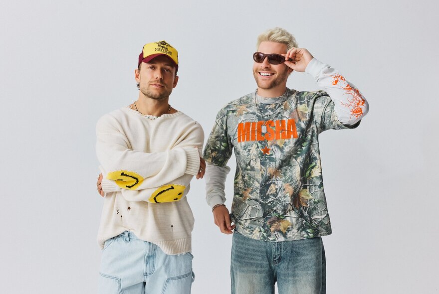 Electronic duo Sidepiece, two men standing side-by-side against a plain white background, wearing casual streetwear.