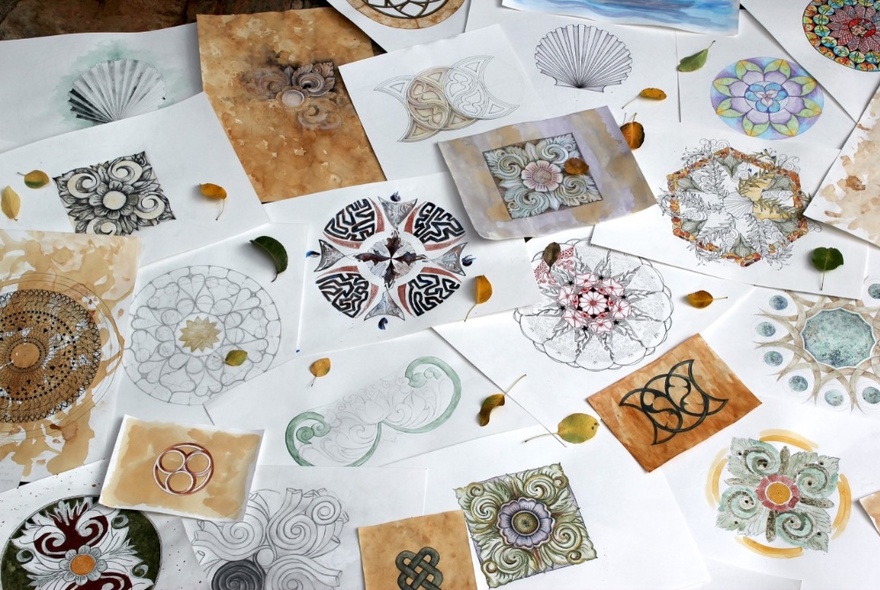 Examples of mandala artworks on a white table.