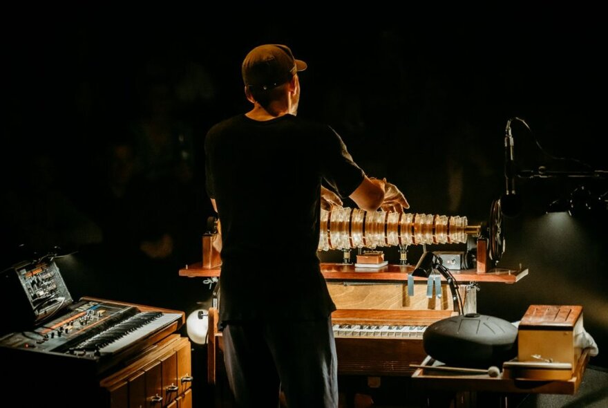 German composer and musician, Nils Frahm, standing at an electronic keyboard with another to his left.