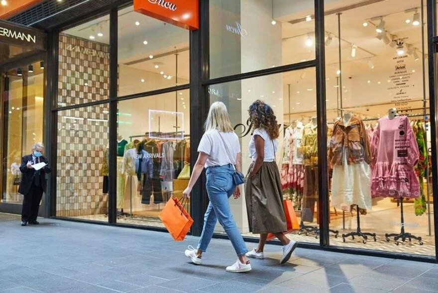 Two women shopping in a laneway.