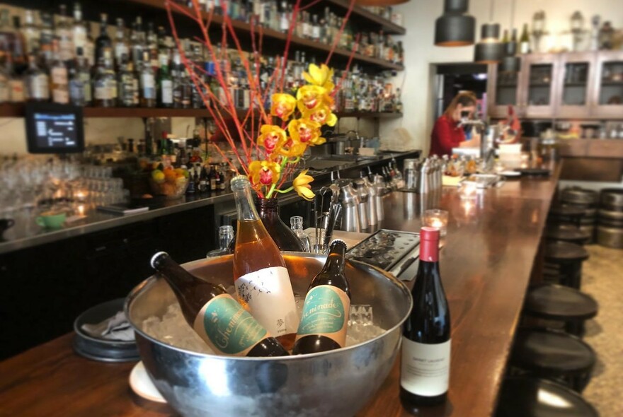 Bottles of wine in an ice bucket in a wine bar.