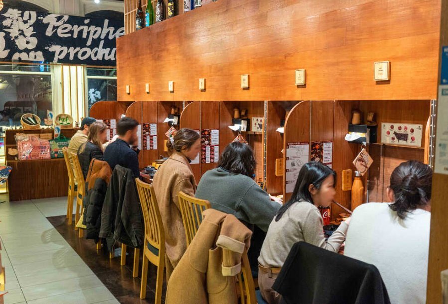 People sitting at booths in a restaurant