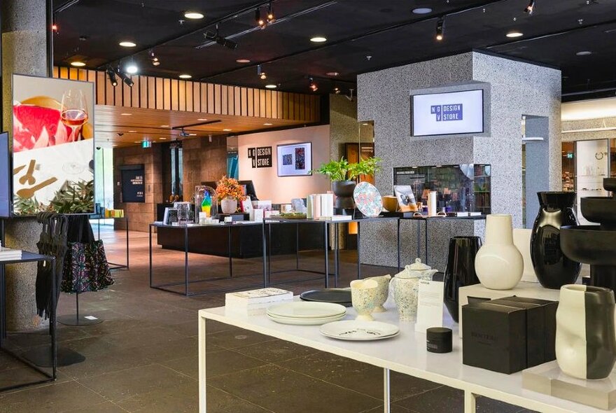 Store interior with tables containing pottery and other items. 