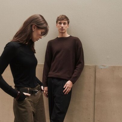 Two young models wearing brown winter clothing.